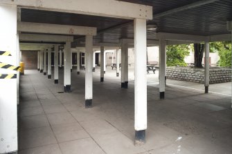 Covered paved area to Gilmore House. View from S.