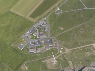 Oblique aerial view of part of the Forss Wind Farm and remains of the radio station, looking SE.