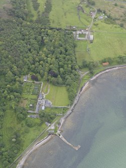 Oblique aerial view centred on Tongue House and Tongue Mains, looking SW.