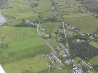 General oblique aerial view of Tongue, centred on St Andrew's Church, manse and the hotel, looking NNE.