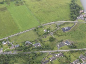 General oblique aerial view of Tongue, centred on St Andrew's Church and manse, looking WNW.