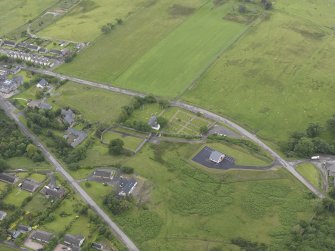 General oblique aerial view of Tongue, centred on St Andrew's Church and manse, looking SW.