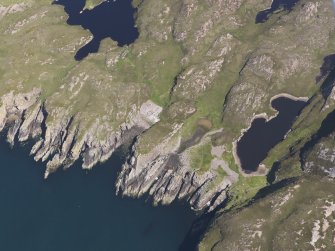 Oblique aerial view of the buildings and enclosures on Priest Island, looking NE.
