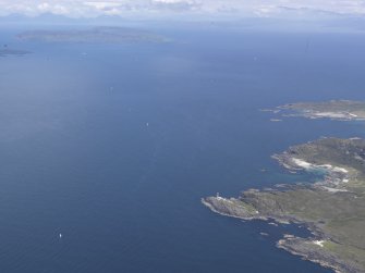 Oblique aerial view of Ardnamurchan lighthouse with Eigg beyond, looking N.