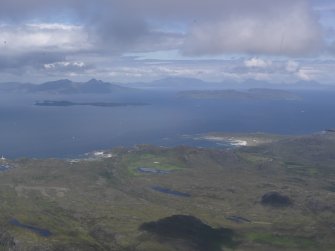 Oblique aerial view of Sanna and Portuairk with Eigg, Muck and Rum beyond, looking N.