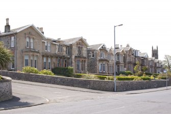 General view from NE showing semi-detached and terraced houses comprising Elysium Terrace, 33-44 Mount Stuart Road, Craigmore, Rothesay, Bute