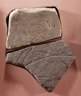 View of Pictish symbol stone fragment with replica fragment below (flash)