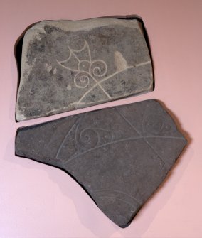 View of Pictish symbol stone fragment with replica fragment below (available light)