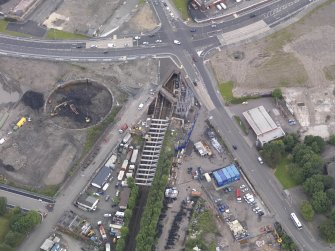 Oblique aerial view of Dalmarnock Station during construction works, taken from the SSE.