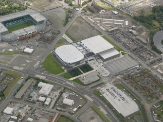 Oblique aerial view of the Glasgow Commonwealth Games Site during construction works, taken from the SW.