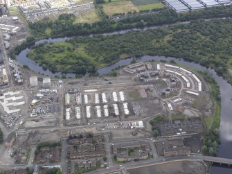 Oblique aerial view of the Glasgow Commonwealth Games Site during construction works, taken from the SW.