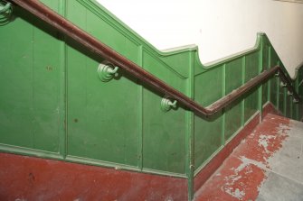 Interior. Detail of bannister and dado rail of side entrance staircase.