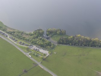 Oblique aerial view of the sluices on the new cut of the River Leven, looking ENE.