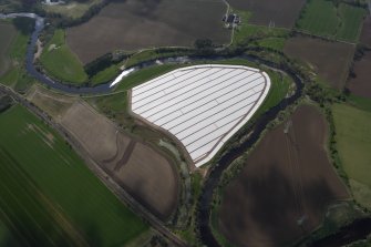 General oblique aerial view of River Earn, Strathearn centred on the plastic ground cover, looking SE.