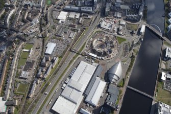 General oblique aerial view of the River Clyde and the Scottish Exhibition and Conference Centre showing construction of the Hyrdo, looking SE.