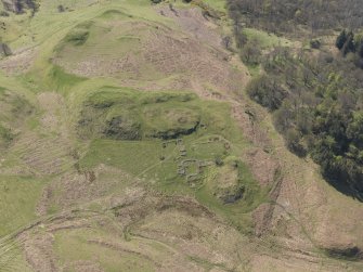 Oblique aerial view of the remains of the farmstead, looking SSE.