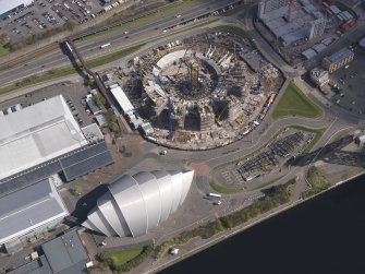 Oblique aerial view of the Scottish Exhibition and Conference Centre showing construction of the Hyrdo, looking NE.