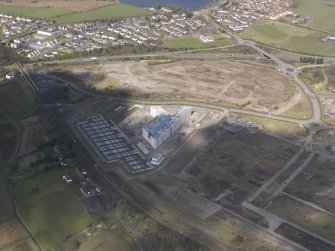 Oblique aerial view of the construction of the Gartcosh Industrial estate on the site of the Gartcosh Steel Mill, looking NW.