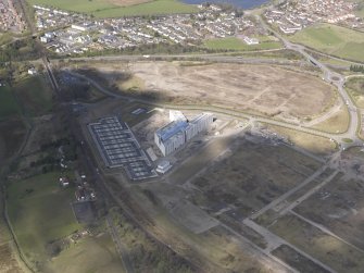 Oblique aerial view of the construction of the Gartcosh Industrial estate on the site of the Gartcosh Steel Mill, looking WNW.