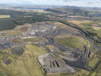 General oblique aerial view of St Ninian's Open Cast Mine, centred on the Sculptured Landscape By Charles Jenks, taken from the SSW.