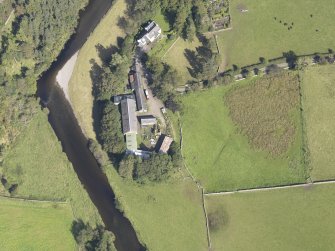 Oblique aerial view of Drumelzier Castle, taken from the SW.