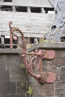 Detail of cast iron lamp bracket on east entrance pavillion.