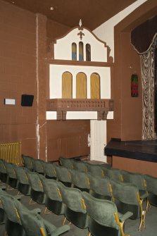 Auditorium seating and 'little house' to left of screen.