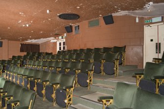 Auditorium. Balcony seating and curved wall of projection room.