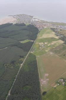 General oblique aerial view of the excavation of the settlement at Clarkly Hill with Burghead beyond, looking WNW.