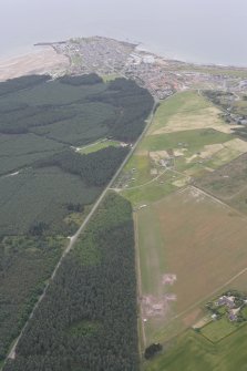 General oblique aerial view of the excavation of the settlement at Clarkly Hill with Burghead beyond, looking WNW.