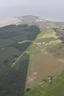 General oblique aerial view of the excavation of the settlement at Clarkly Hill with Burghead beyond, looking WNW.