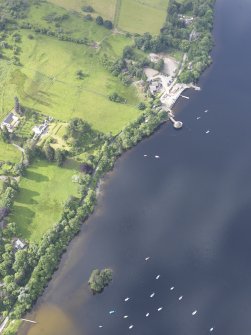 Oblique aerial view of the reconstruction of the crannog and the Isle of Spar, looking SSW.