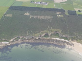 Oblique aerial view of the Covesea Caves, looking SSE.