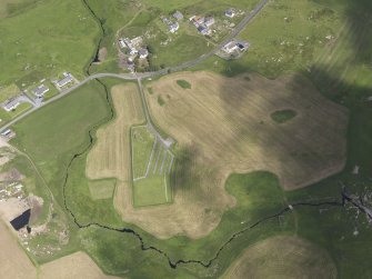 Oblique aerial view of Ardnis showing the parchmarks of the possible enclosure, looking N.