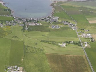 General oblique aerial view of St Margarets Hope and South Ronaldsay Golf Course, looking NNE.