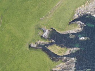 Oblique aerial view of Riggins of Kami, Deerness and the Stack of Mustack, looking NW.