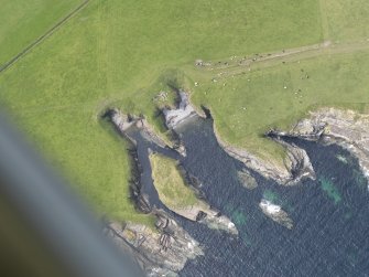 Oblique aerial view of Riggins of Kami, Deerness and the Stack of Mustack, looking W.