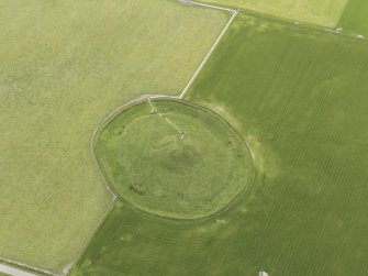 Oblique aerial view of Maeshowe Chambered Cairn, looking SSW.
