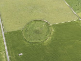 Oblique aerial view of Maeshowe Chambered Cairn, looking SSE.