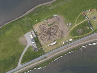 Oblique aerial view of the excavations at Ness of Brodgar, looking SW.