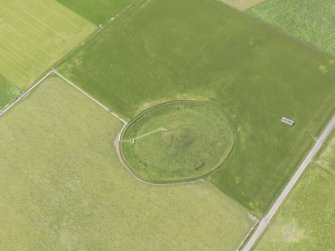Oblique aerial view of Maeshowe Chambered Cairn, looking SW.