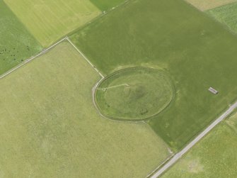 Oblique aerial view of Maeshowe Chambered Cairn, looking SW.