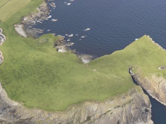 Oblique aerial view centred on the broch at Lamb Head, Stronsay, looking NE.