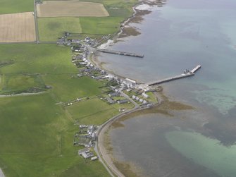 Oblique aerial view centred on Whitehall Village, Stronsay, looking WNW.