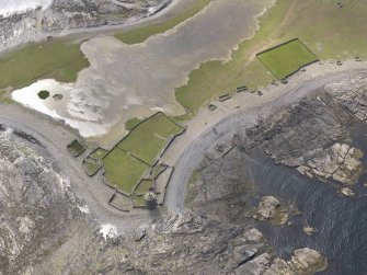 Oblique aerial view centred on the enclosures and planticrues, and the Old Beacon, looking W.