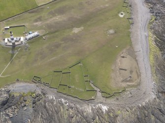 Oblique aerial view centred on the enclosures, looking SW.