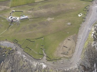 Oblique aerial view centred on the enclosures, looking SW.