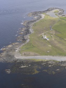 Oblique aerial view centred on the enclosures and lighthouse at Dennis Head, looking SW.