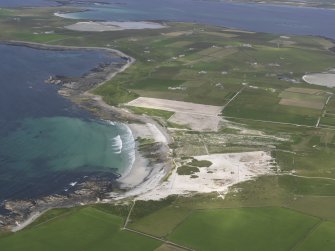 General oblique aerial view of Westray, centred on the Links of Noltland, looking NE.
