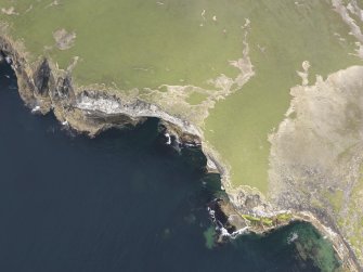 Oblique aerial view of the cliffs and erosion at Flag Ber on the west coast of Westray, looking NE.